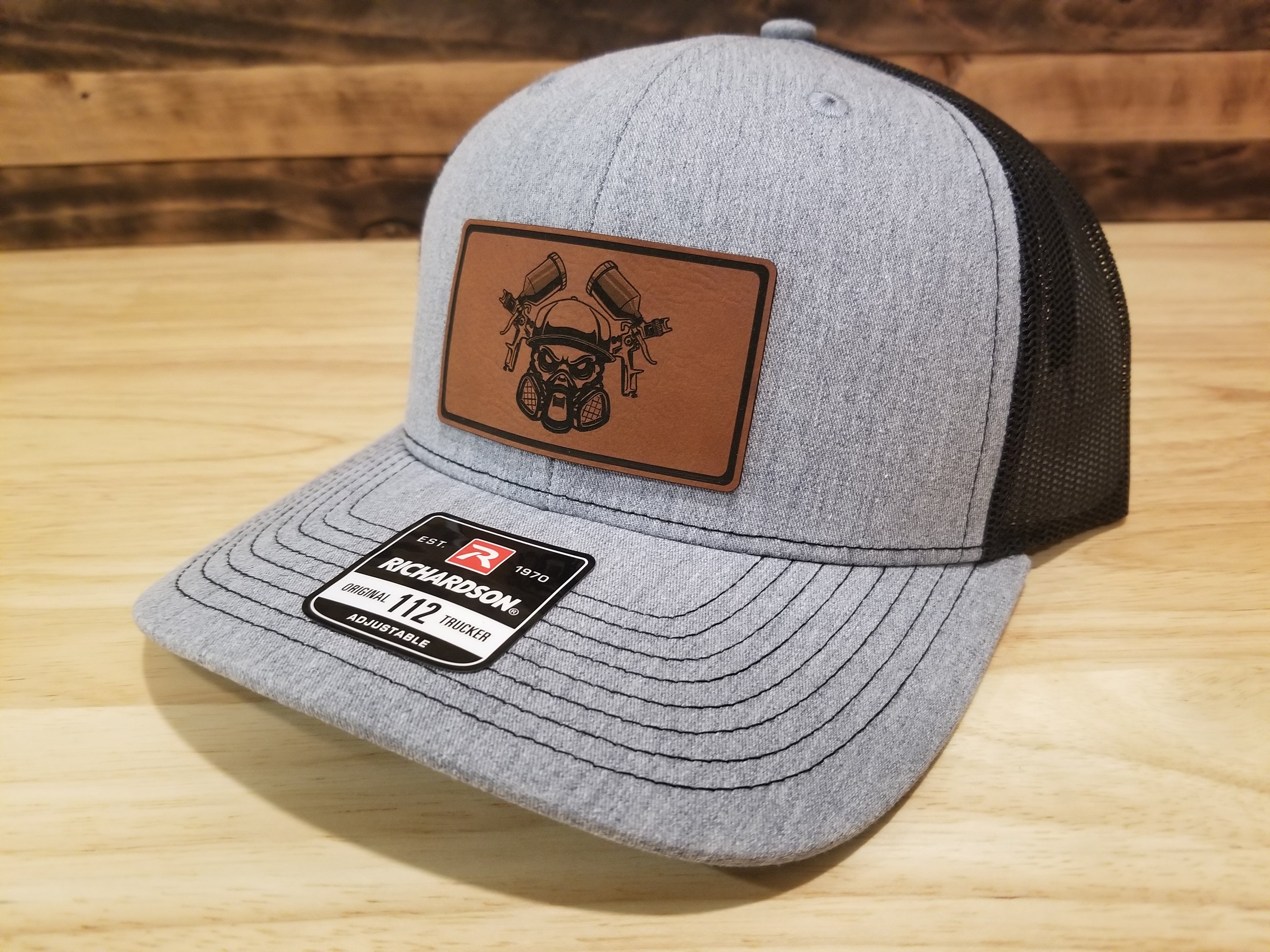 Body Shop Merch Hat with Rawhide patch featuring a skull with paint guns