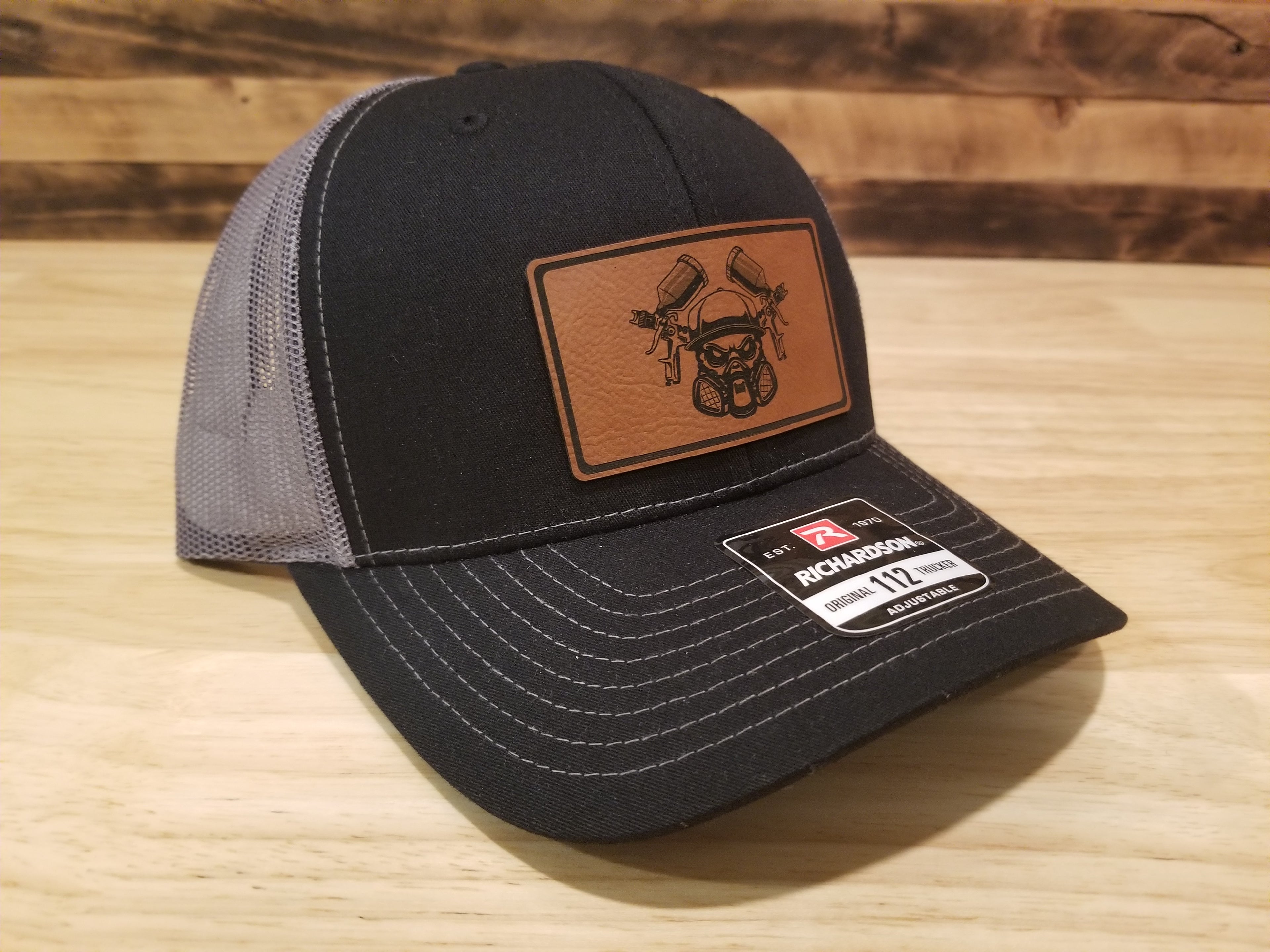 Body Shop Merch Hat with Rawhide patch featuring a skull with paint guns