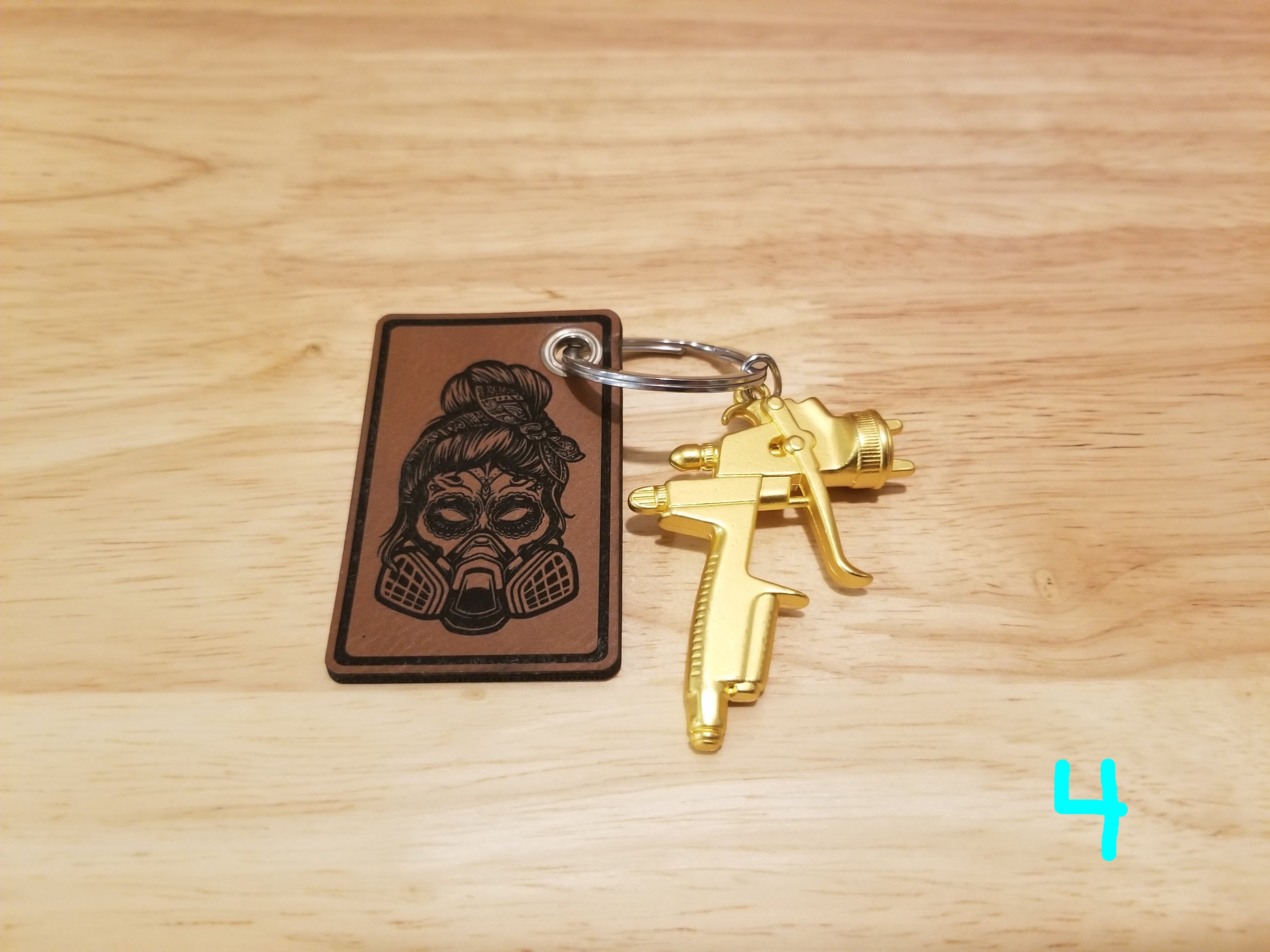 Body Shop Merch branded rawhide patch with Gold paint gun Keychain