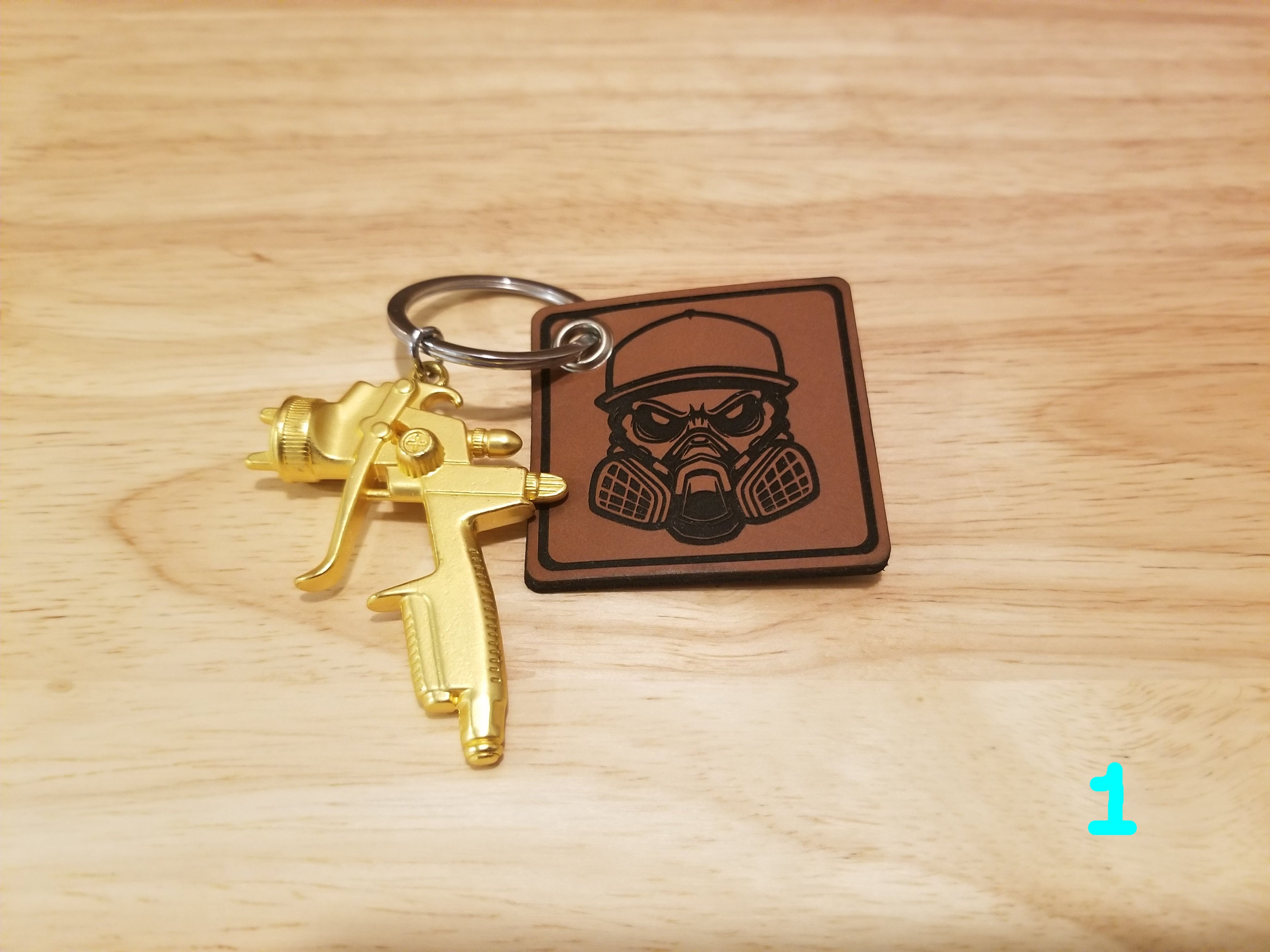 Body Shop Merch branded rawhide patch with Gold paint gun Keychain