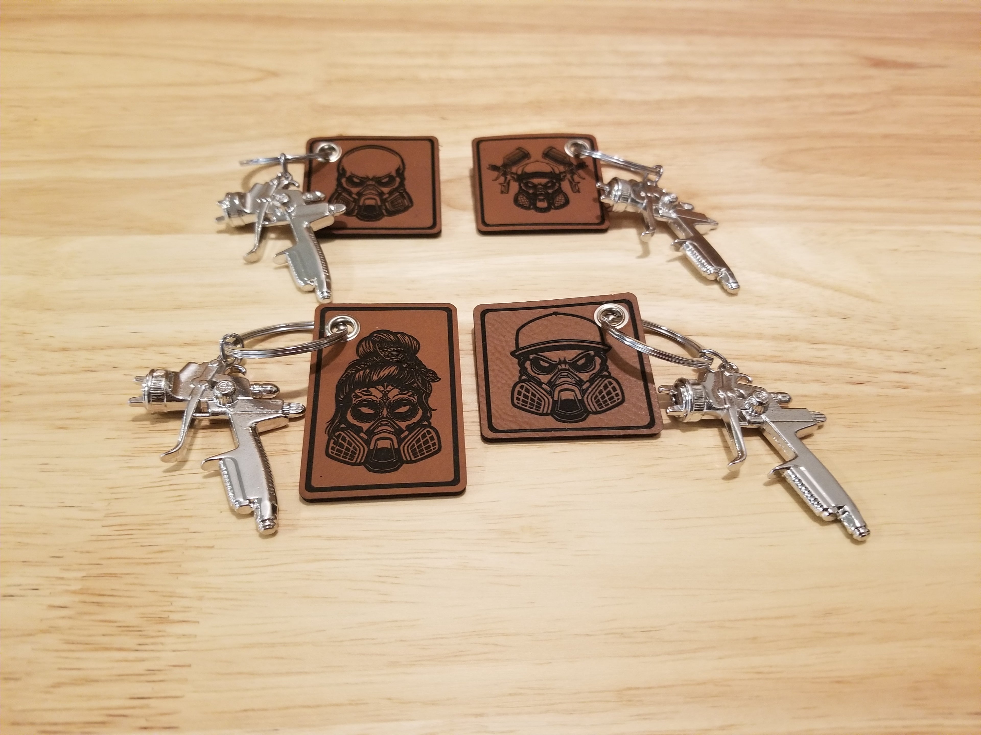 Body Shop Merch branded rawhide patch with Silver paint gun Keychain