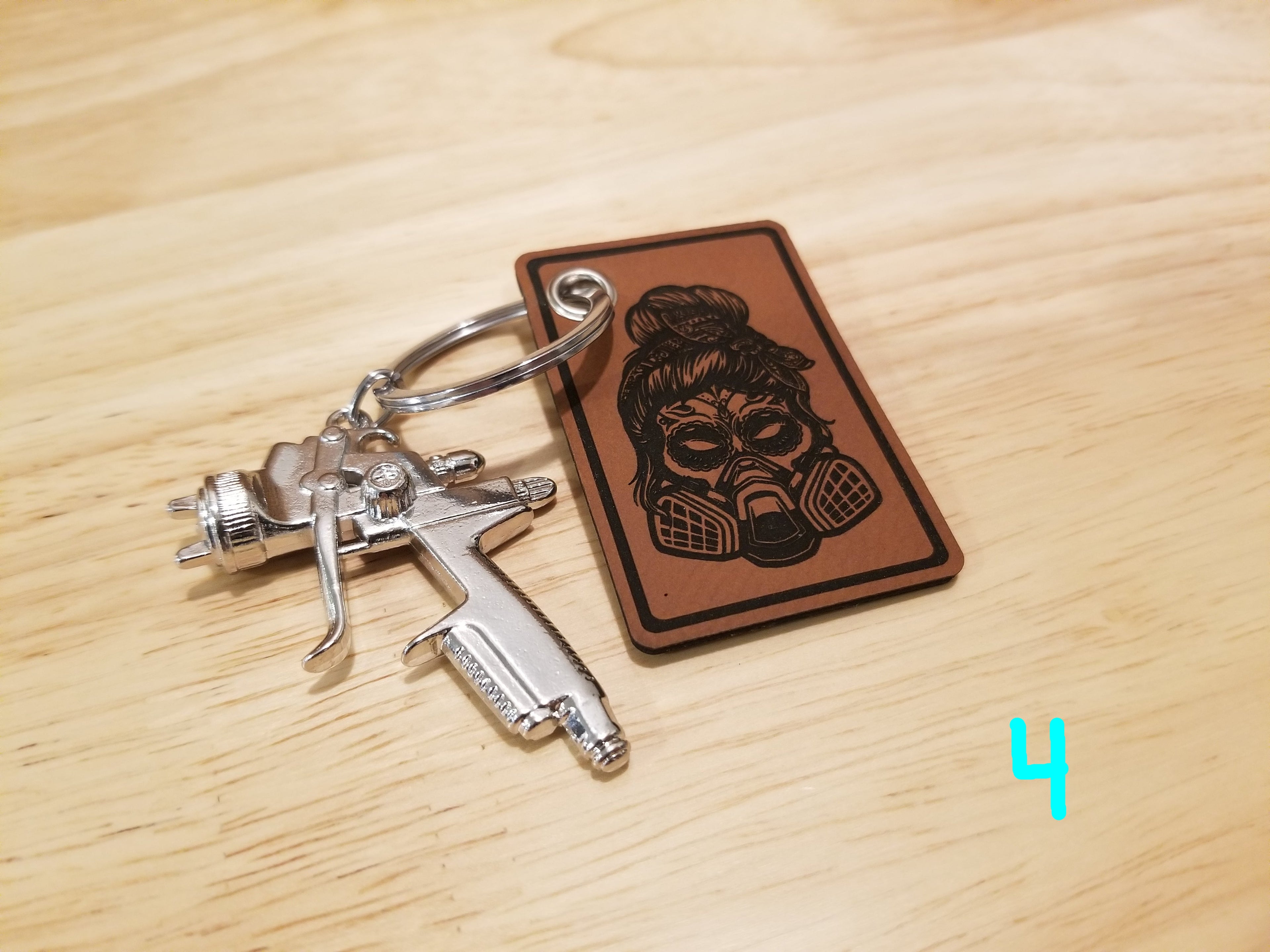 Body Shop Merch branded rawhide patch with Silver paint gun Keychain