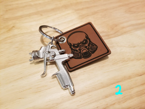 Body Shop Merch branded rawhide patch with Silver paint gun Keychain